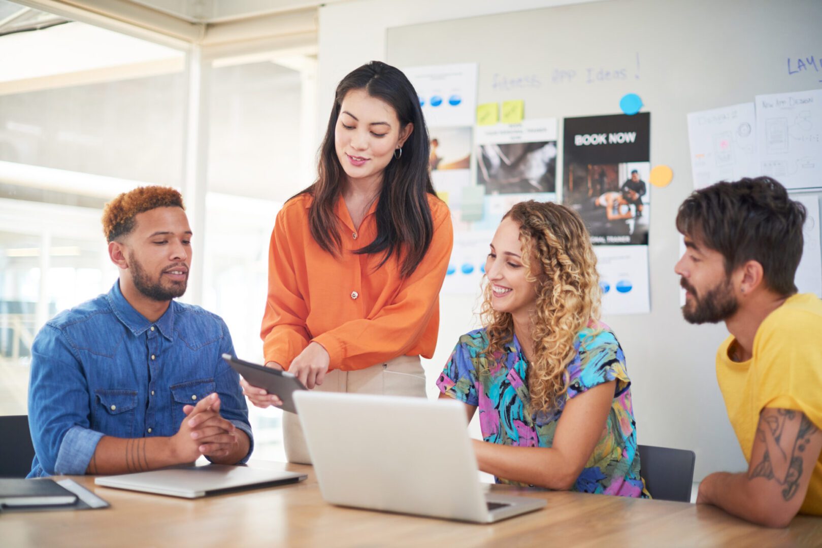 Three colleagues collaborating on a project in an office setting.